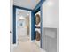 Hallway featuring a stacked washer and dryer unit and doorway into bathroom at 7932 Sailboat Key S Blvd # 806, South Pasadena, FL 33707