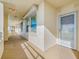 Well-lit hallway with windows along one side, leading to residential unit entrance at 7932 Sailboat Key S Blvd # 806, South Pasadena, FL 33707