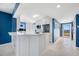 Modern kitchen with white cabinets, stone countertops, and stainless steel appliances near the entrance at 7932 Sailboat Key S Blvd # 806, South Pasadena, FL 33707