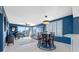 Open concept living room with piano, slider to balcony, and dining area at 7932 Sailboat Key S Blvd # 806, South Pasadena, FL 33707
