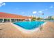 Enjoy the outdoors at this community pool with lounge chairs and a clubhouse surrounded by palm trees at 7932 Sailboat Key S Blvd # 806, South Pasadena, FL 33707