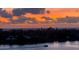 Coastal sunset view with a single boat in motion at 7932 Sailboat Key S Blvd # 806, South Pasadena, FL 33707