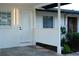 Exterior view of a home with a white exterior door, showing architectural details and design at 8412 Stillbrook Ave, Tampa, FL 33615