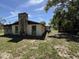 View of the back exterior and grassy yard of the property at 9526 Eastfield Rd, Thonotosassa, FL 33592