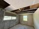 Unfinished room with exposed block walls and open ceiling requiring renovations at 9526 Eastfield Rd, Thonotosassa, FL 33592