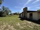 Back exterior view showing the yard and the side of the home at 9526 Eastfield Rd, Thonotosassa, FL 33592