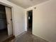 Unfinished room featuring bare concrete floors and white walls and two door ways at 9526 Eastfield Rd, Thonotosassa, FL 33592