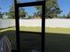 Screened in porch with a view of a well maintained, grassy backyard enclosed by a white fence at 9613 Jasmine Brook Crk, Land O Lakes, FL 34638