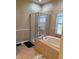 Bathroom with a tiled shower stall and a separate soaking tub beneath a window at 9613 Jasmine Brook Crk, Land O Lakes, FL 34638