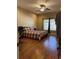 Spacious bedroom with hardwood floors, a ceiling fan, and a comfortable bed with a patterned comforter at 9613 Jasmine Brook Crk, Land O Lakes, FL 34638