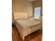 Comfortable bedroom featuring white furniture, warm toned walls, and laminate wood floor at 9613 Jasmine Brook Crk, Land O Lakes, FL 34638