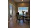 Cozy breakfast nook with a round glass table and seating for four, next to a door that leads to the outside at 9613 Jasmine Brook Crk, Land O Lakes, FL 34638