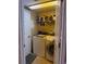 Efficient laundry room features a washer, dryer, and shelving for storage solutions at 9613 Jasmine Brook Crk, Land O Lakes, FL 34638