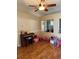Bright living space featuring stylish ceiling fan, hardwood floors, and a piano at 9613 Jasmine Brook Crk, Land O Lakes, FL 34638