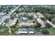 Aerial community view showcasing manicured lawns, swimming pool, tennis courts and surrounding greenery at 9700 Starkey Rd # 321, Seminole, FL 33777