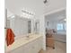 Bathroom featuring a vanity with modern lighting, an adjacent bedroom, and tiled floors at 9700 Starkey Rd # 321, Seminole, FL 33777