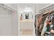 View through closet to a bathroom featuring neutral tiling and cabinetry at 9700 Starkey Rd # 321, Seminole, FL 33777