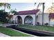 Inviting community entrance with arched walkways, lush landscaping, and a quaint bridge over a waterway at 9700 Starkey Rd # 321, Seminole, FL 33777