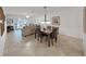Open-concept dining area with modern lighting fixture and view to living room and outside patio at 9700 Starkey Rd # 321, Seminole, FL 33777