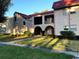 Charming exterior elevation featuring a well-maintained lawn, mature shrubs, and inviting architectural details at 9700 Starkey Rd # 321, Seminole, FL 33777