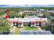 Attractive condo building with red tile roof, manicured landscaping, and ample parking at 9700 Starkey Rd # 321, Seminole, FL 33777
