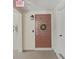 Condo entrance featuring a decorative wreath, updated lighting, and secure entry system at 9700 Starkey Rd # 321, Seminole, FL 33777