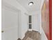 Entry hallway with closet and screen door, featuring modern flooring and neutral paint at 9700 Starkey Rd # 321, Seminole, FL 33777