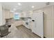 Cozy kitchen showcasing ample counter space, white appliances and sleek modern flooring at 9700 Starkey Rd # 321, Seminole, FL 33777