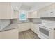 Bright kitchen with white cabinetry, stylish countertops, and stainless steel appliances at 9700 Starkey Rd # 321, Seminole, FL 33777