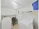 Convenient laundry room with washer, dryer, storage cabinets, and ample space for laundry tasks at 9700 Starkey Rd # 321, Seminole, FL 33777