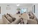 Comfortable living room with neutral-toned sofa, ceiling fan, and access to outdoor patio at 9700 Starkey Rd # 321, Seminole, FL 33777