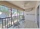 Relax on the screened patio with tile flooring, neutral tones, and comfortable seating, perfect for enjoying the outdoors at 9700 Starkey Rd # 321, Seminole, FL 33777