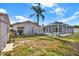 Fenced backyard with lawn, a pool with screen enclosure, and a shed at 10014 118Th Way, Seminole, FL 33772