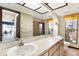 Bathroom with double sinks, shower and a window at 10014 118Th Way, Seminole, FL 33772