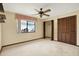 Carpeted bedroom with closet and ceiling fan at 10014 118Th Way, Seminole, FL 33772