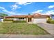 Charming single-story home with stone accents, well-maintained landscaping, and an attached two-car garage at 10014 118Th Way, Seminole, FL 33772