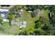 Expansive lot featuring the home, storage units, RV, outbuildings, and mature landscaping, perfect for investment or development at 10034 Burton St, New Port Richey, FL 34654