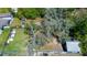 The property has mature trees for privacy and shade, with additional buildings and fencing at 10034 Burton St, New Port Richey, FL 34654