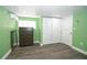 Bedroom with green walls, dark wood furniture, and hardwood flooring at 10034 Burton St, New Port Richey, FL 34654