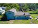 Aerial view of a two-story home with a large backyard and mature trees providing plenty of shade at 10034 Burton St, New Port Richey, FL 34654
