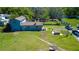Aerial view of a two-story home with a picnic table, hot tub, and ample outdoor space for entertaining at 10034 Burton St, New Port Richey, FL 34654
