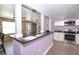 A kitchen offers stainless steel appliances, stone countertops, and white cabinetry at 10034 Burton St, New Port Richey, FL 34654