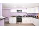 Modern kitchen with white cabinets, granite countertops and stainless steel appliances at 10034 Burton St, New Port Richey, FL 34654