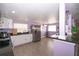 A kitchen showcases stainless steel appliances, white cabinetry, and stone countertops at 10034 Burton St, New Port Richey, FL 34654