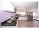 Modern kitchen with white cabinets, granite countertops and stainless steel appliances at 10034 Burton St, New Port Richey, FL 34654