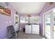 Bright laundry room with modern appliances and a large sliding glass door at 10034 Burton St, New Port Richey, FL 34654