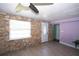 A living room offers stone accent walls and hard surface floors at 10034 Burton St, New Port Richey, FL 34654