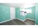 A mint green room displays hard surface floors and a storage nook at 10034 Burton St, New Port Richey, FL 34654
