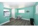 A room showcases hard surface floors and mint-green walls at 10034 Burton St, New Port Richey, FL 34654