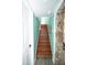 View of wood staircase with stone wall accent and white trim and doors at 10034 Burton St, New Port Richey, FL 34654